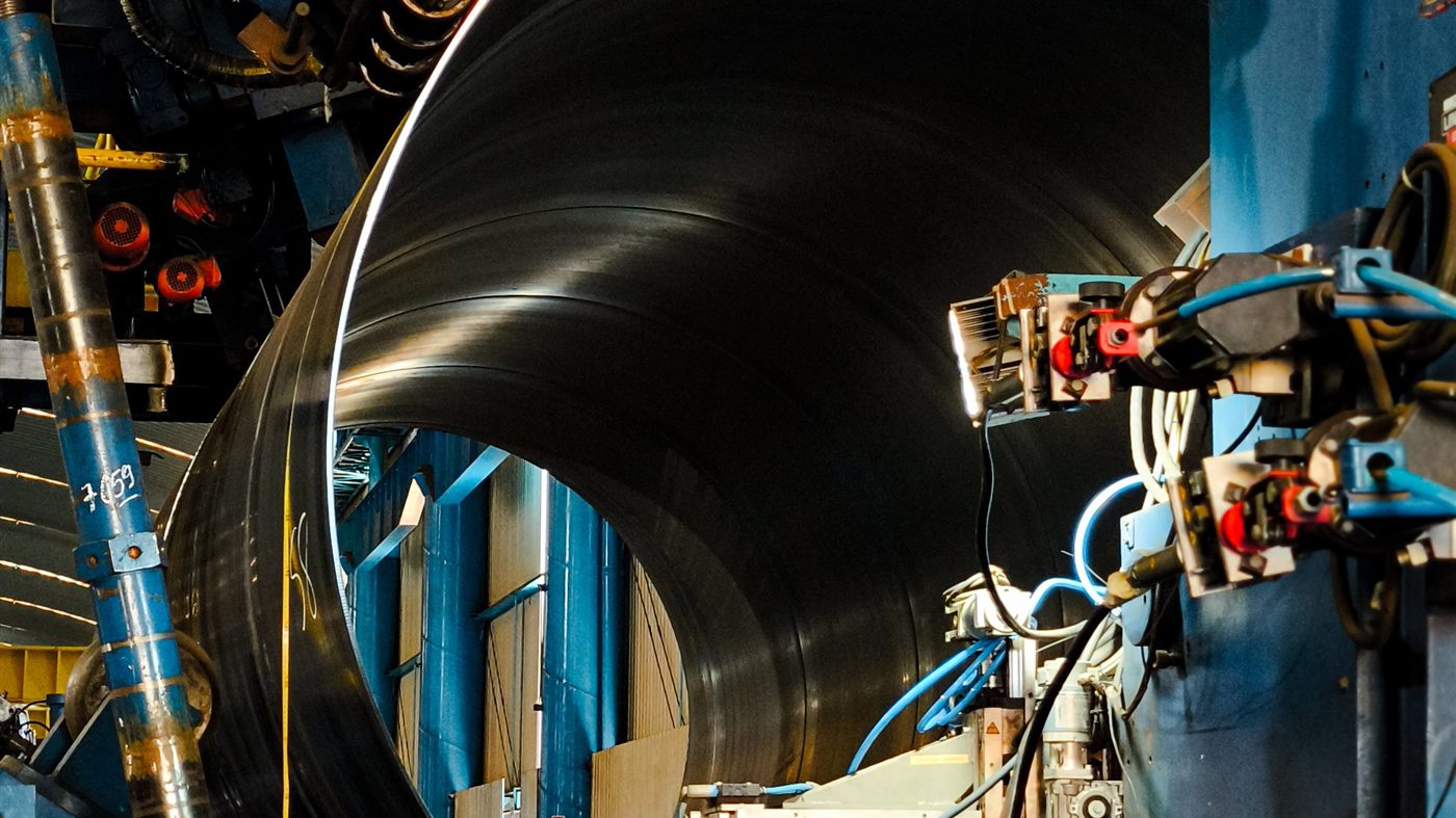 Steel pipe forming line in an industrial facility